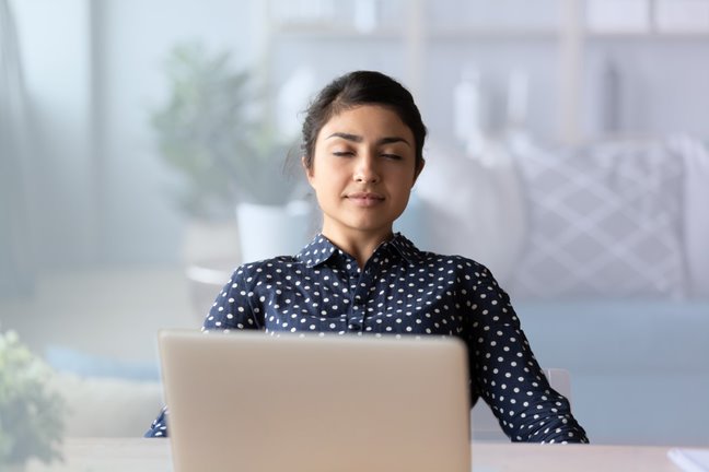 Woman practicing mindfulness at a desk
