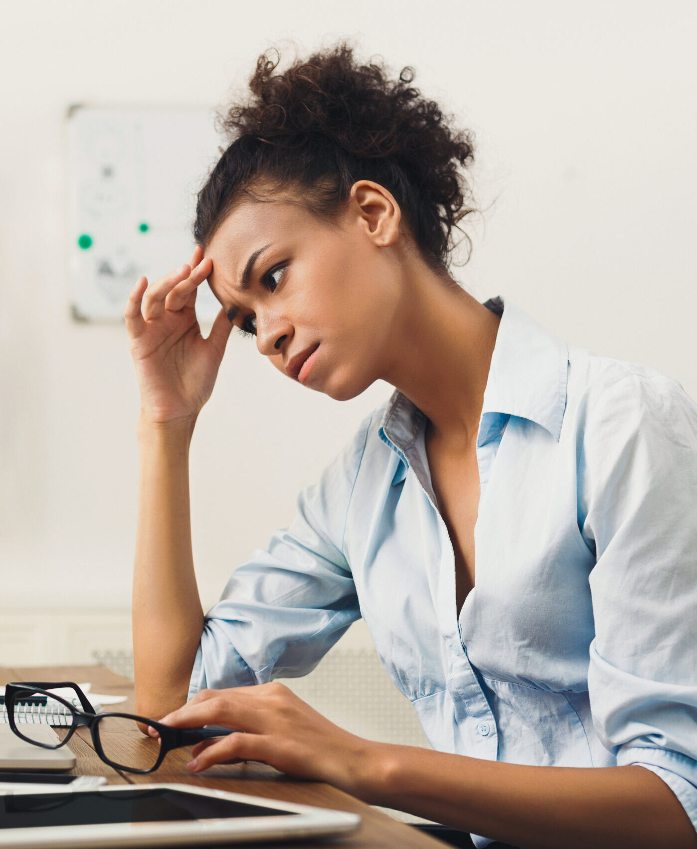 Frustrated business woman with headache at office
