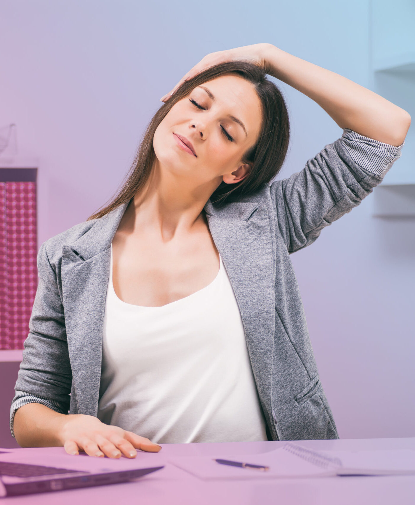Woman practicing mindfulness by stretching at a desk