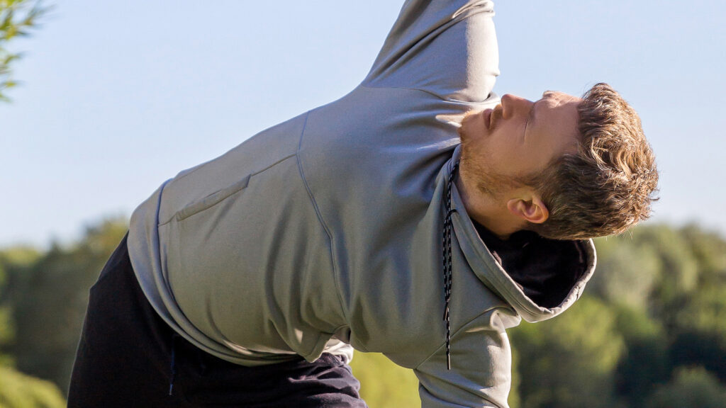 A man stretches in triangle pose