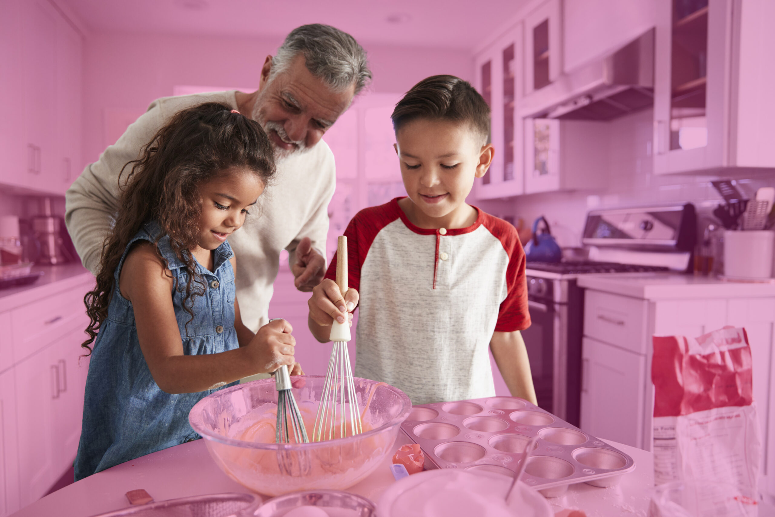 A family cooks together in the kitchen