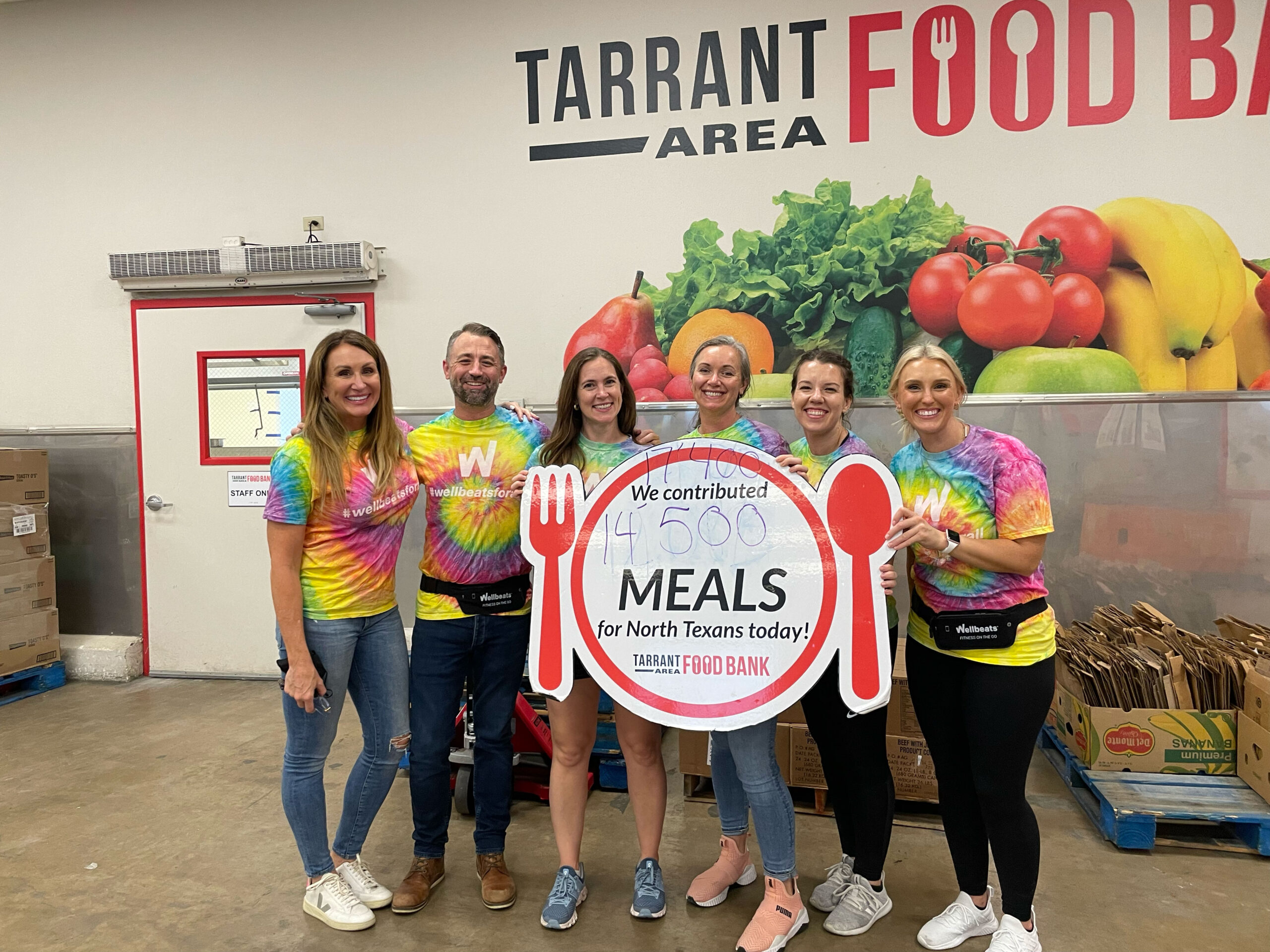 Members of the Wellbeats team pose together at the Tarrant Area Food Bank
